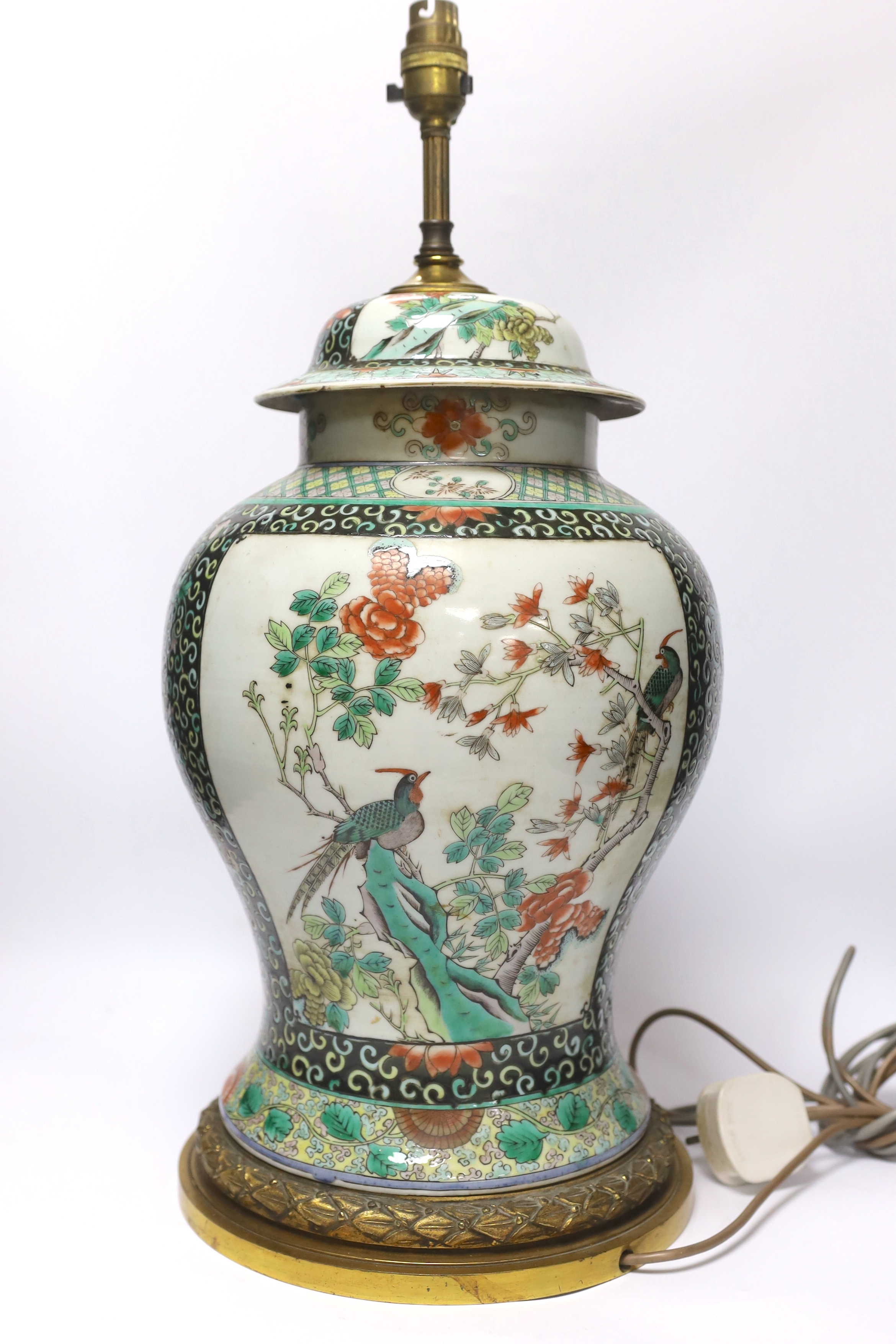 A Chinese famille verte porcelain baluster vase and cover, 19th century, decorated with birds amongst branches and blossom on decorative gilt metal base (now converted to a table lamp and drilled), 56cm total